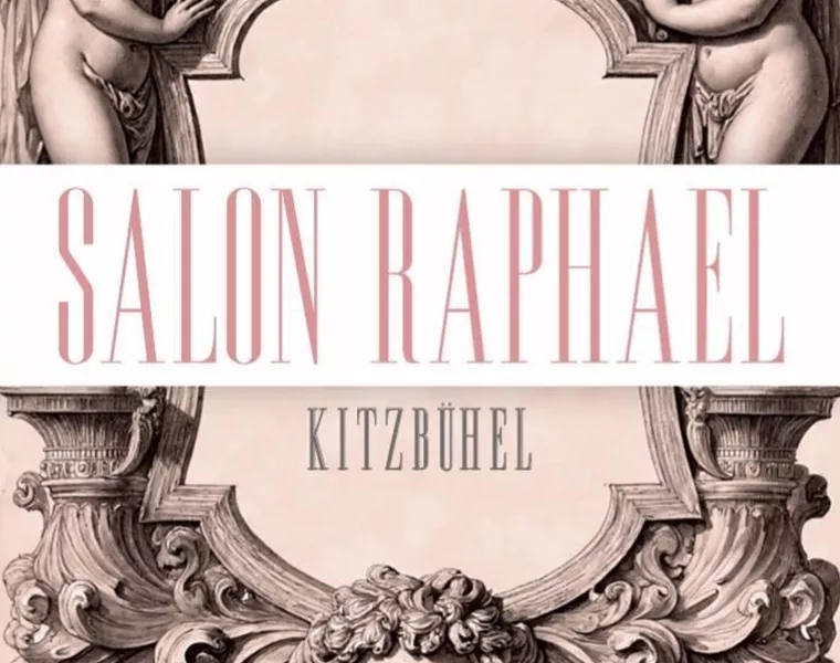 Ein elegantes Logo mit zwei Engeln und einem Löwenkopf. Darunter steht "Salon Raphael Kitzbühel" in stilvoller Schrift.